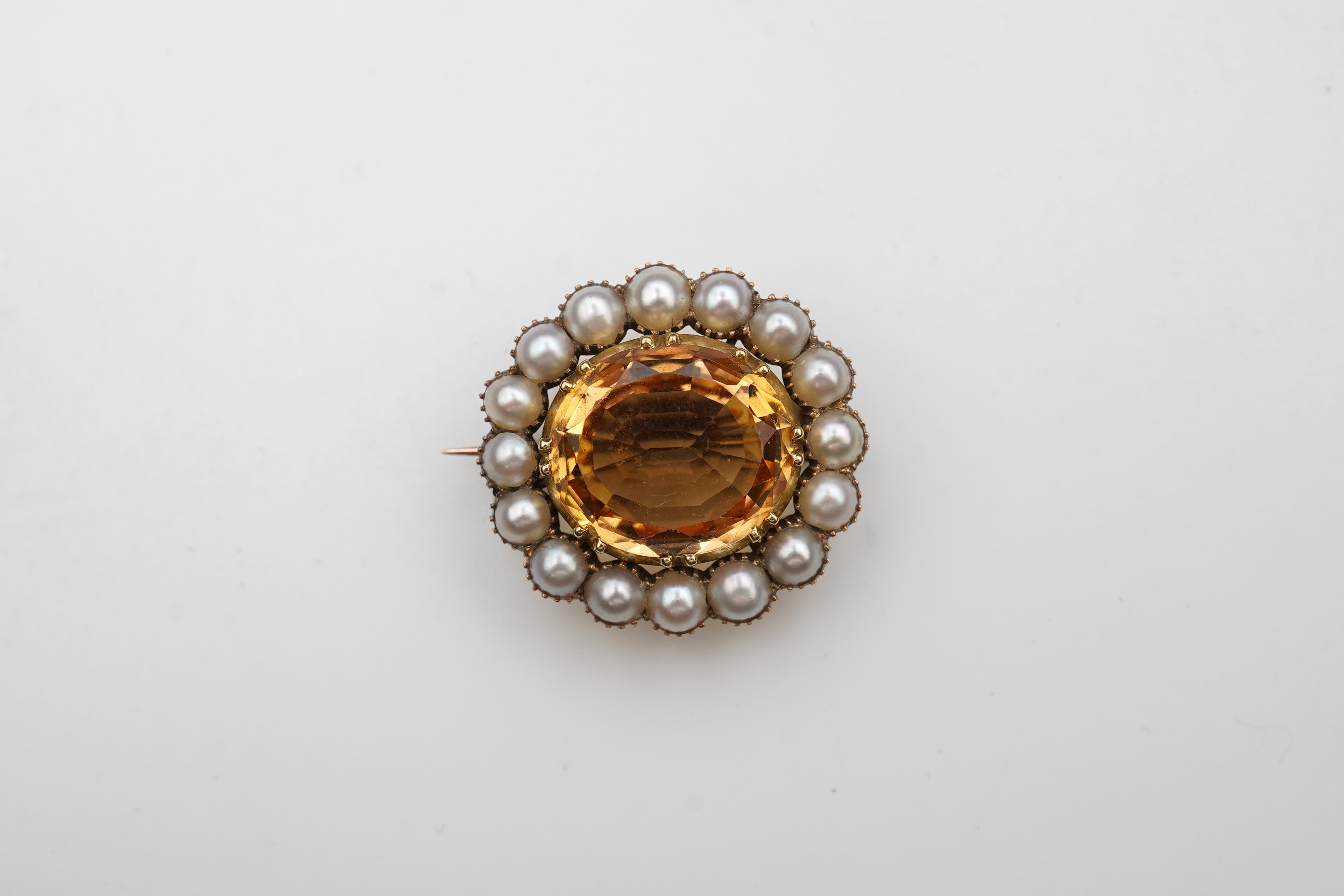 A Victorian topaz and pearl brooch, late 19th century